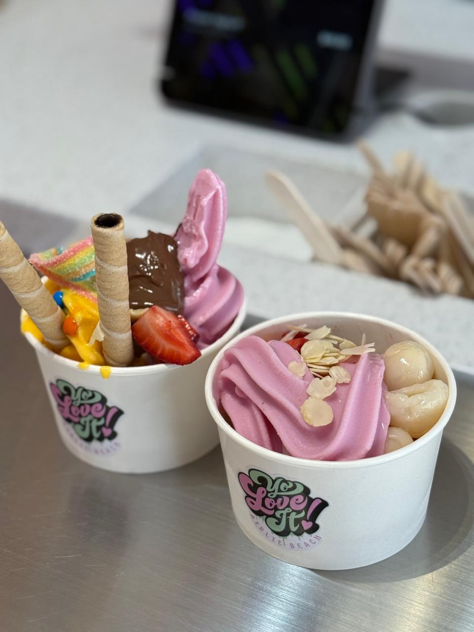 Yo Love It branded frozen yoghurt cups with strawberry froyo and fresh toppings
